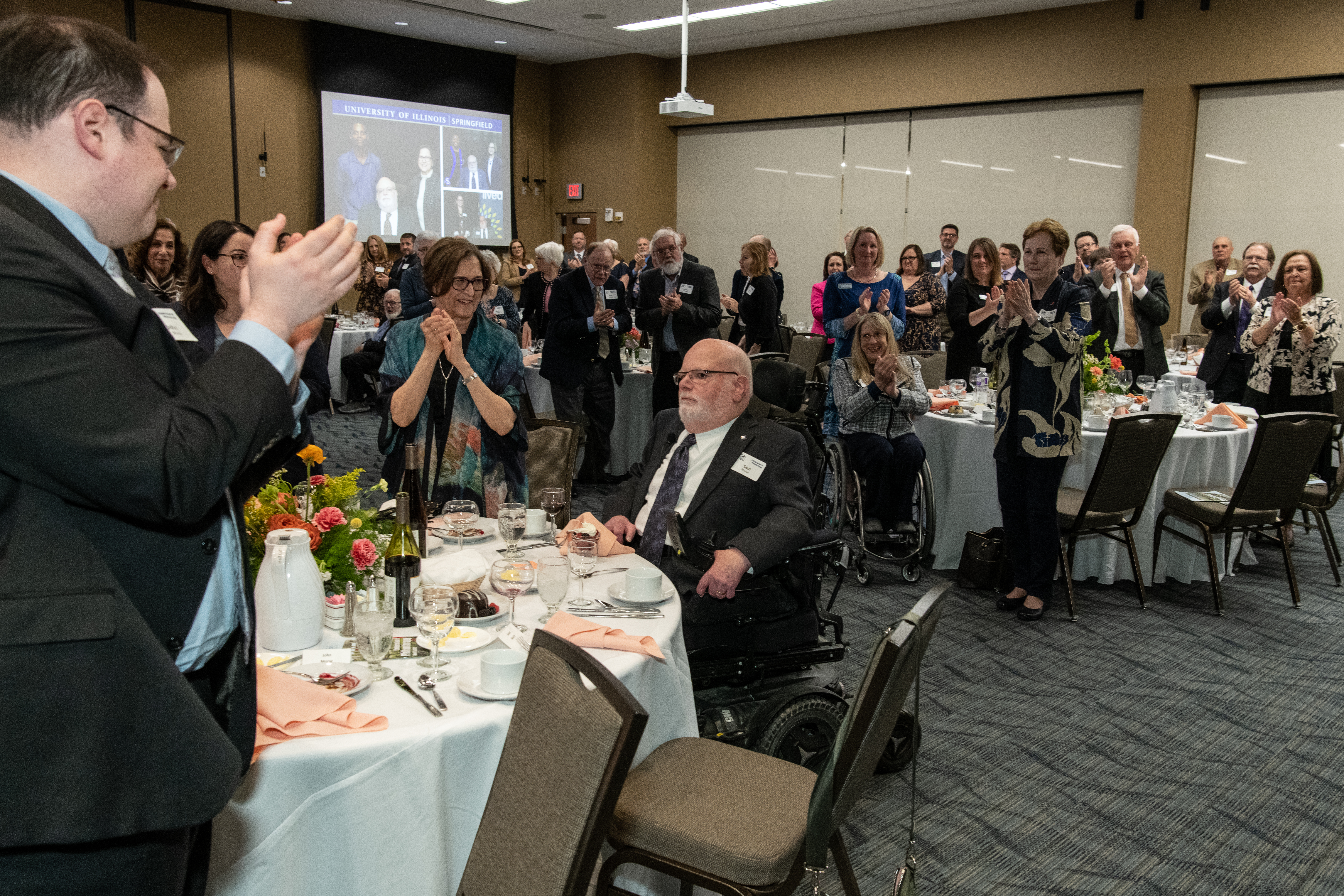 A crowd gives a standing ovation after a winner of an award is announced