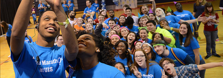 a very large group of students taking a group selfie