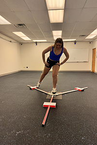 Woman using Y balance equipment