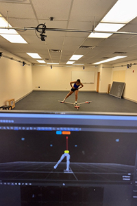 Student motion capture with data on a screen.