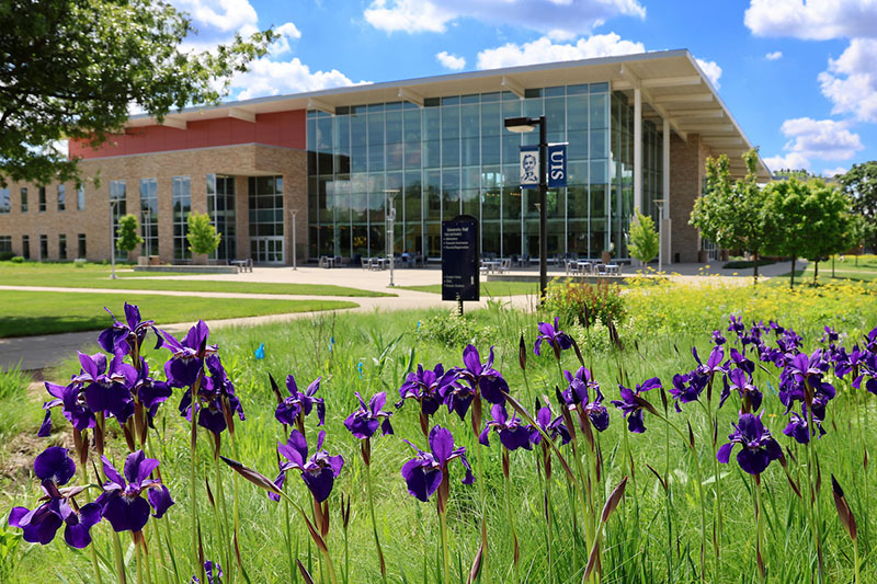 UIS campus building with spring flowers in foreground