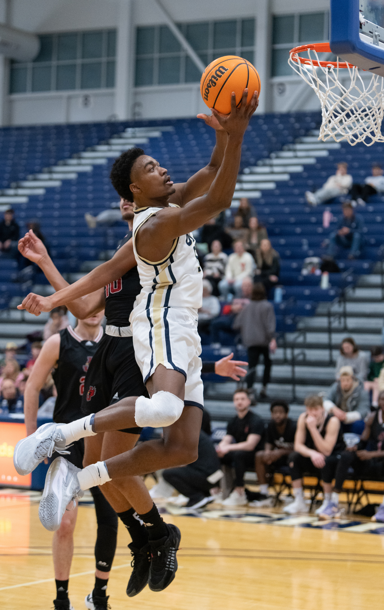 UIS basketball player shoots a layup.
