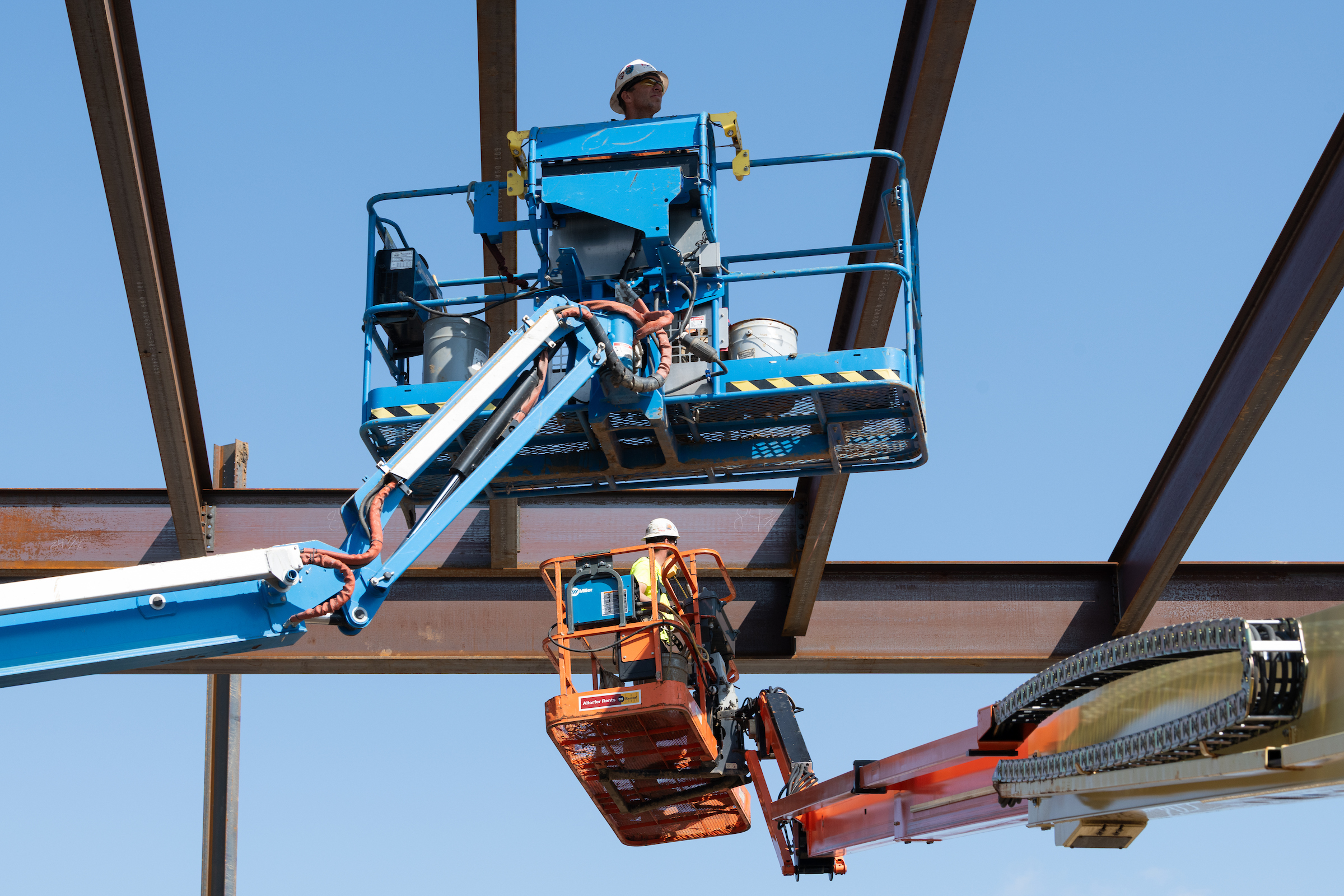 Construction crews investigating installed steel beams to Library Commons.