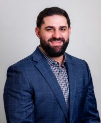 headshot of Adam Unes