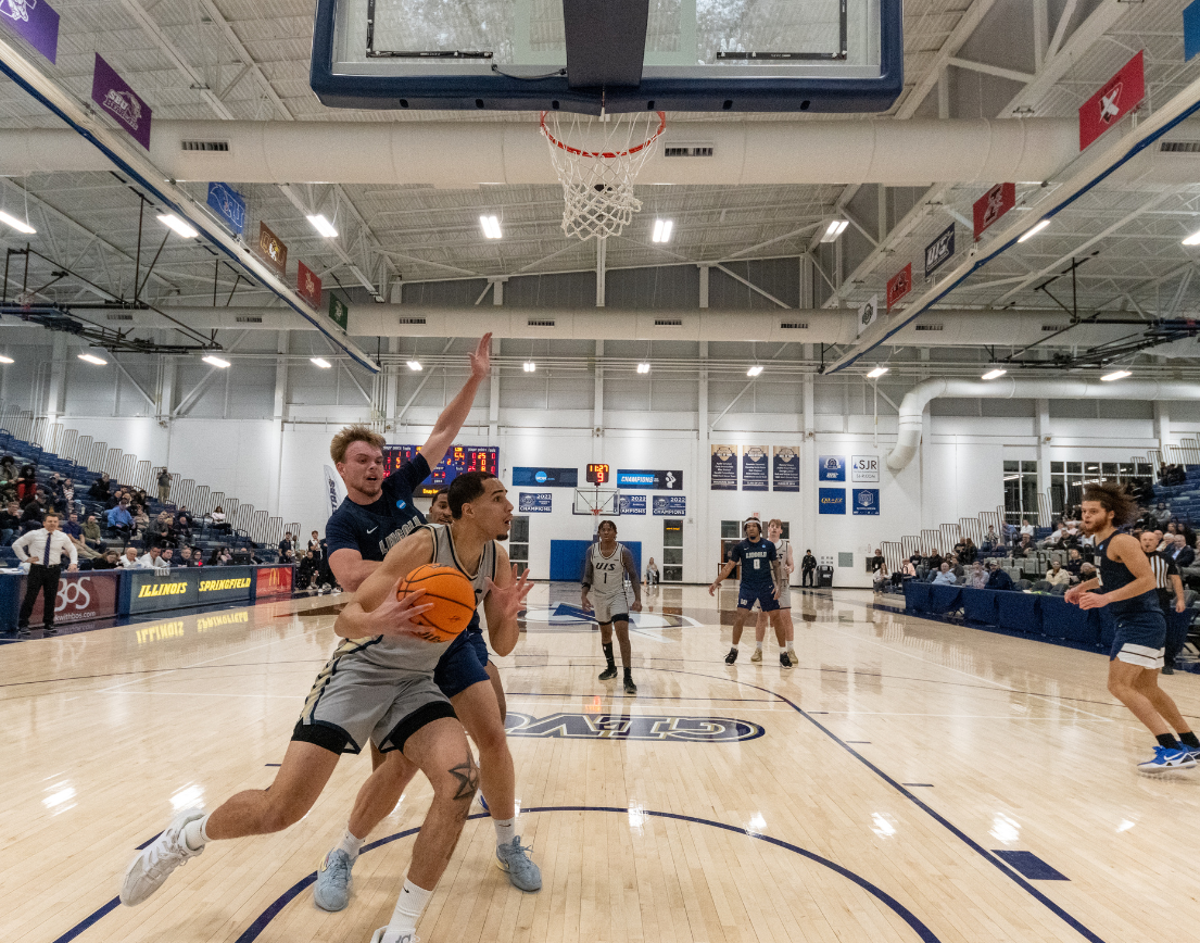 A UIS basketball player goes for a lay-up.