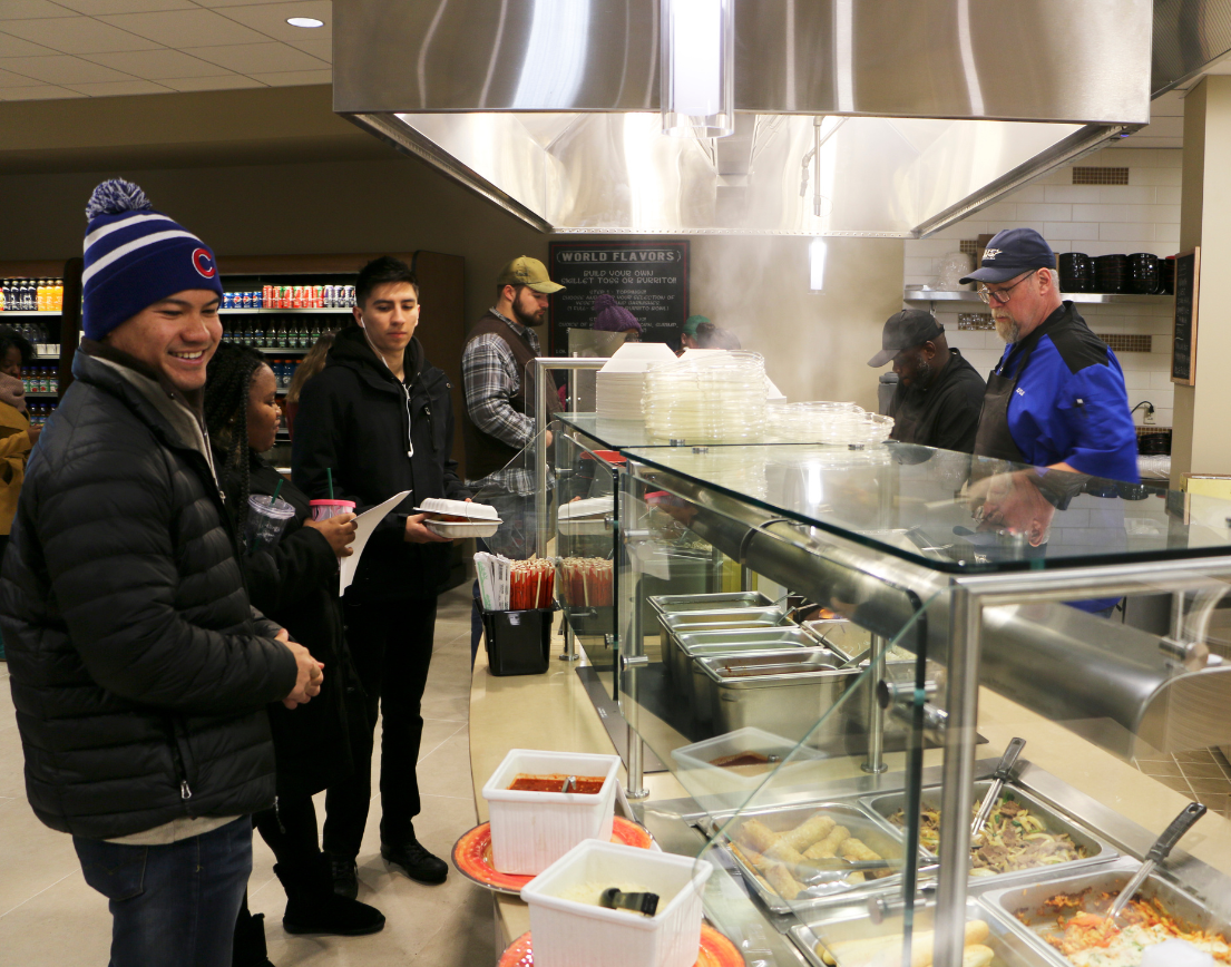 Students waiting in line, cafeteria style.