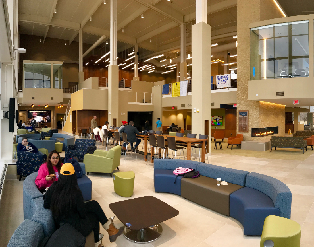 A large, tall room. Scattered with colorful couches and chairs.
