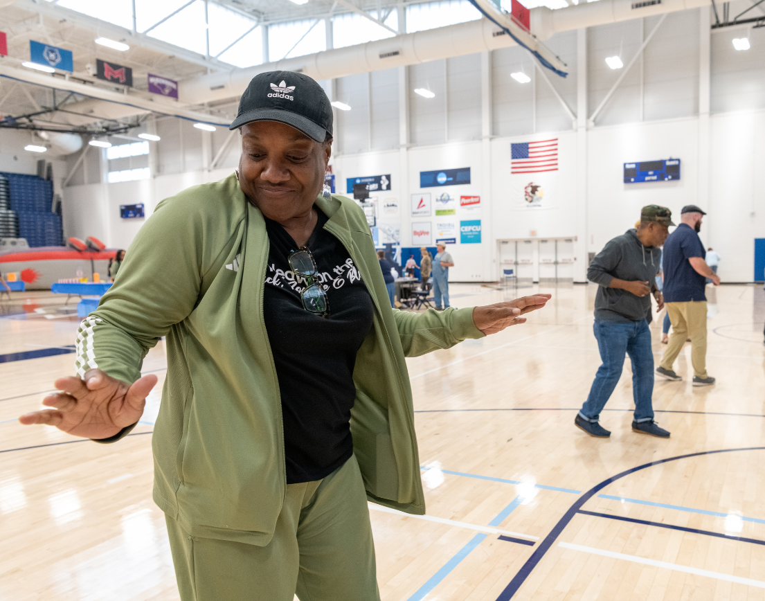 A person in a green track suit dancing.