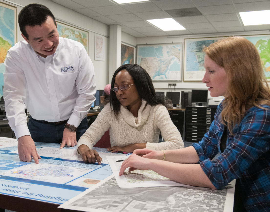 A teacher helping two students.