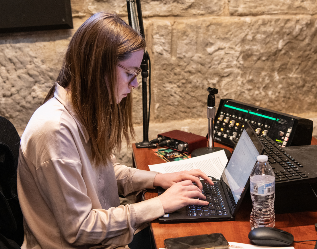A woman typing at a computer.