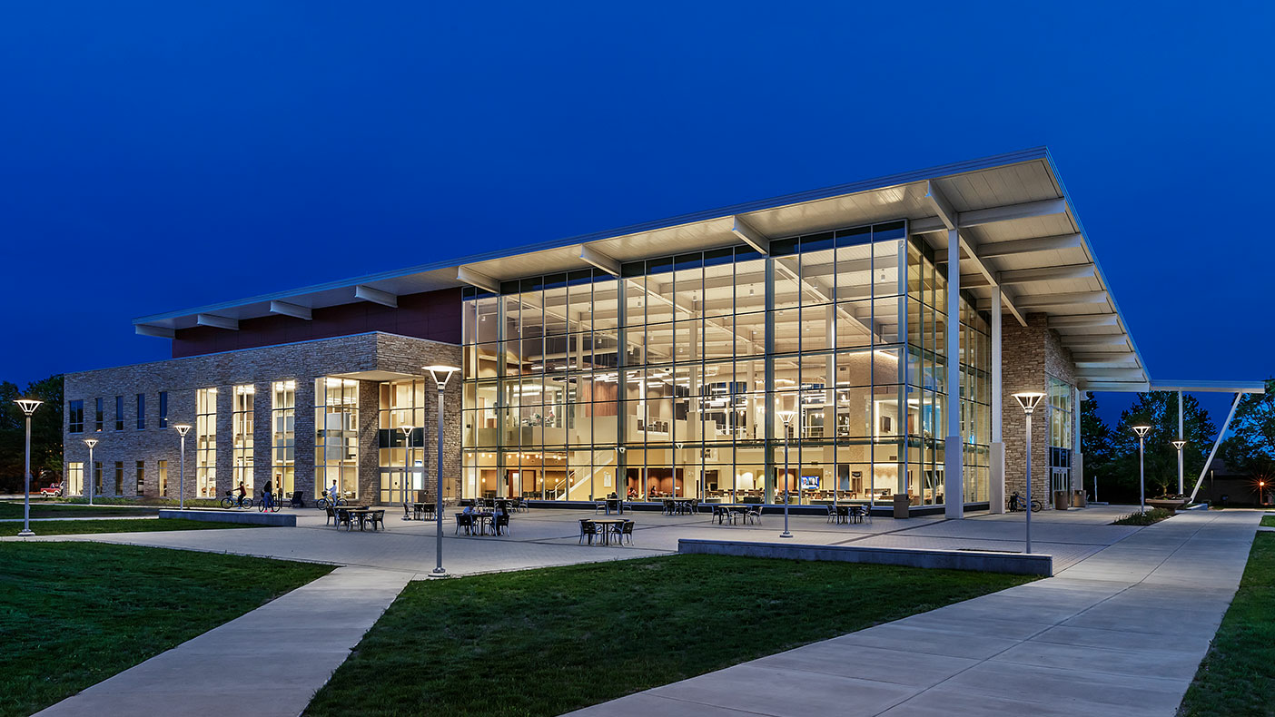 Student union building (main venue) illuminated at night against a deep blue sky.