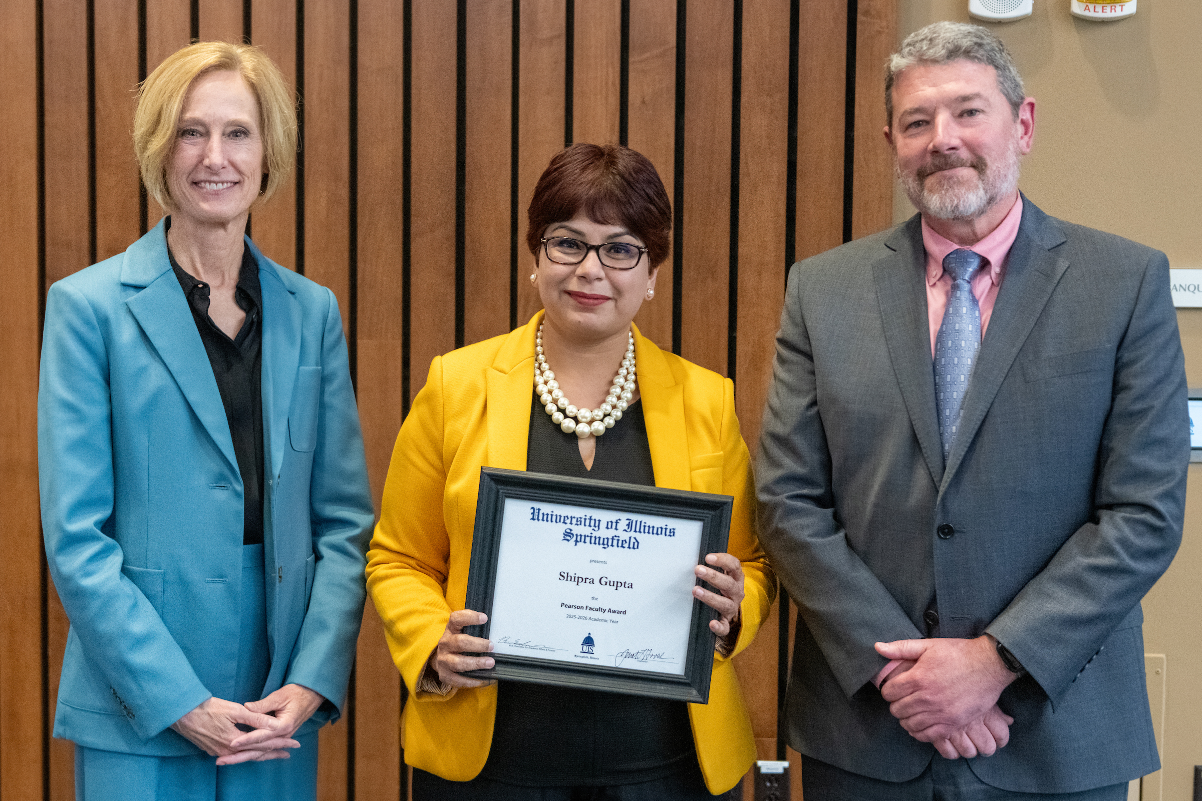 Chancellor Gooch, Shipra Gupta with framed award, Provost Schwab