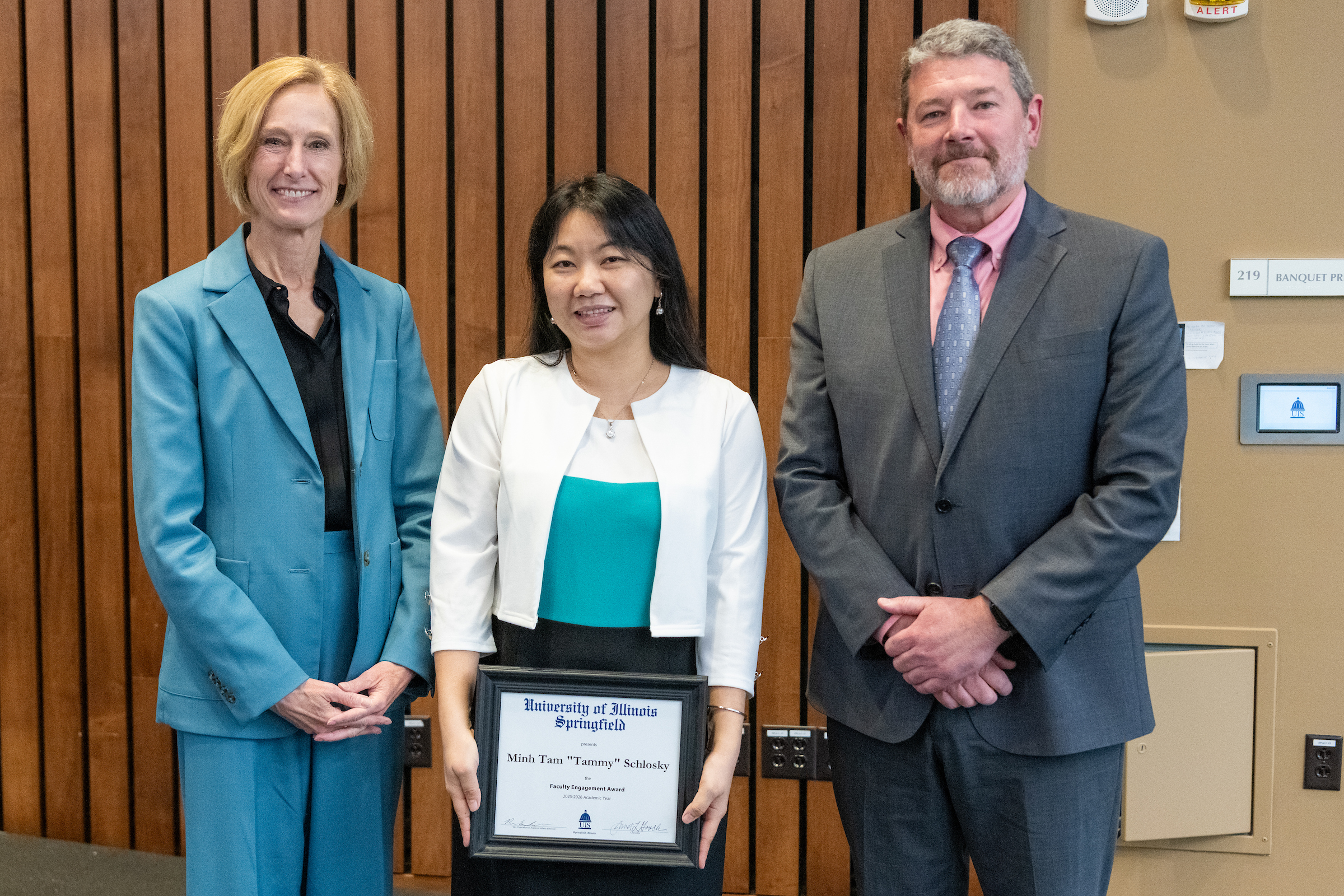Chancellor Gooch, Tammy Schlosky with framed award, Provost Schwab