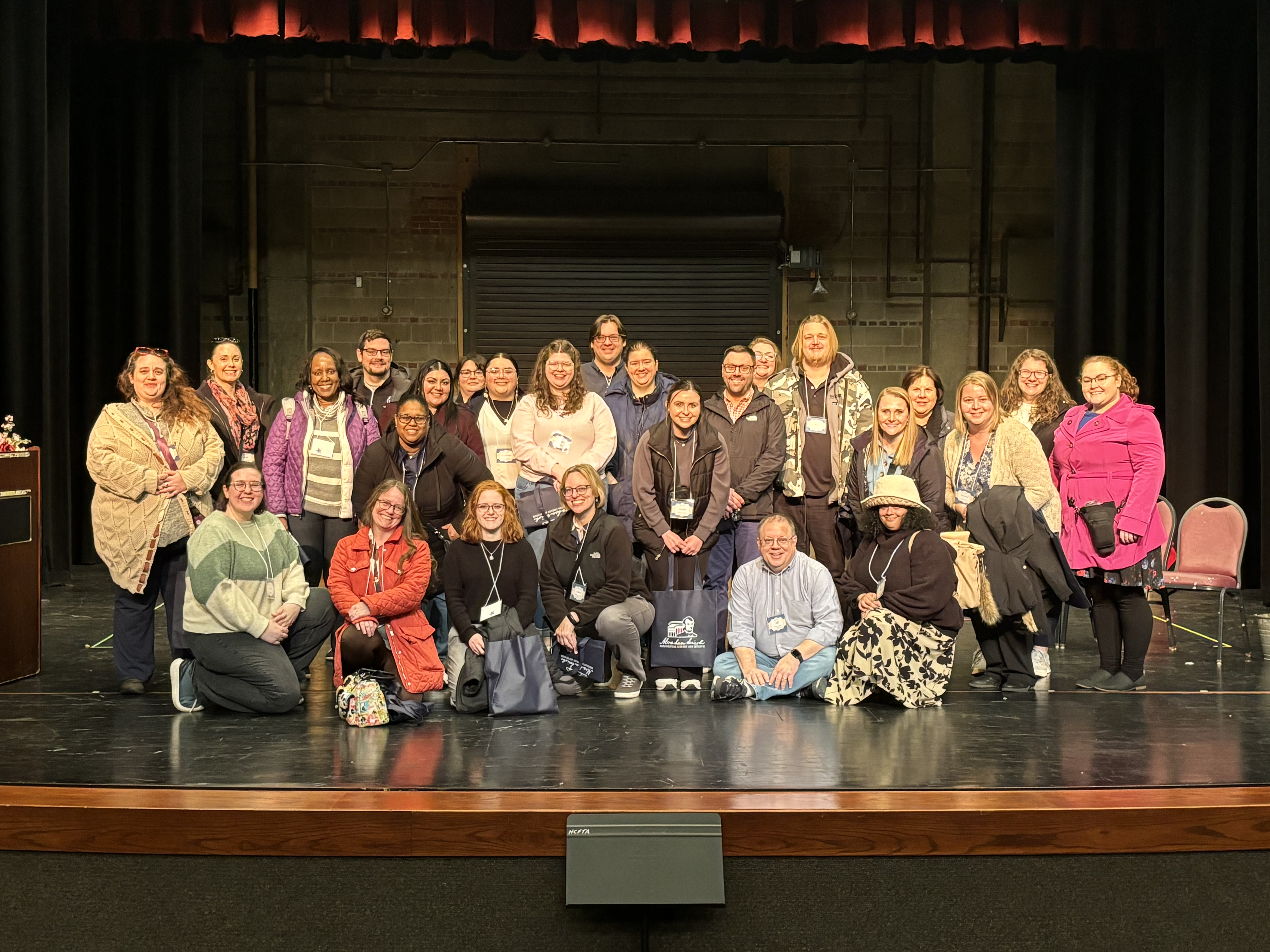 Employees are standing on the stage at PAC