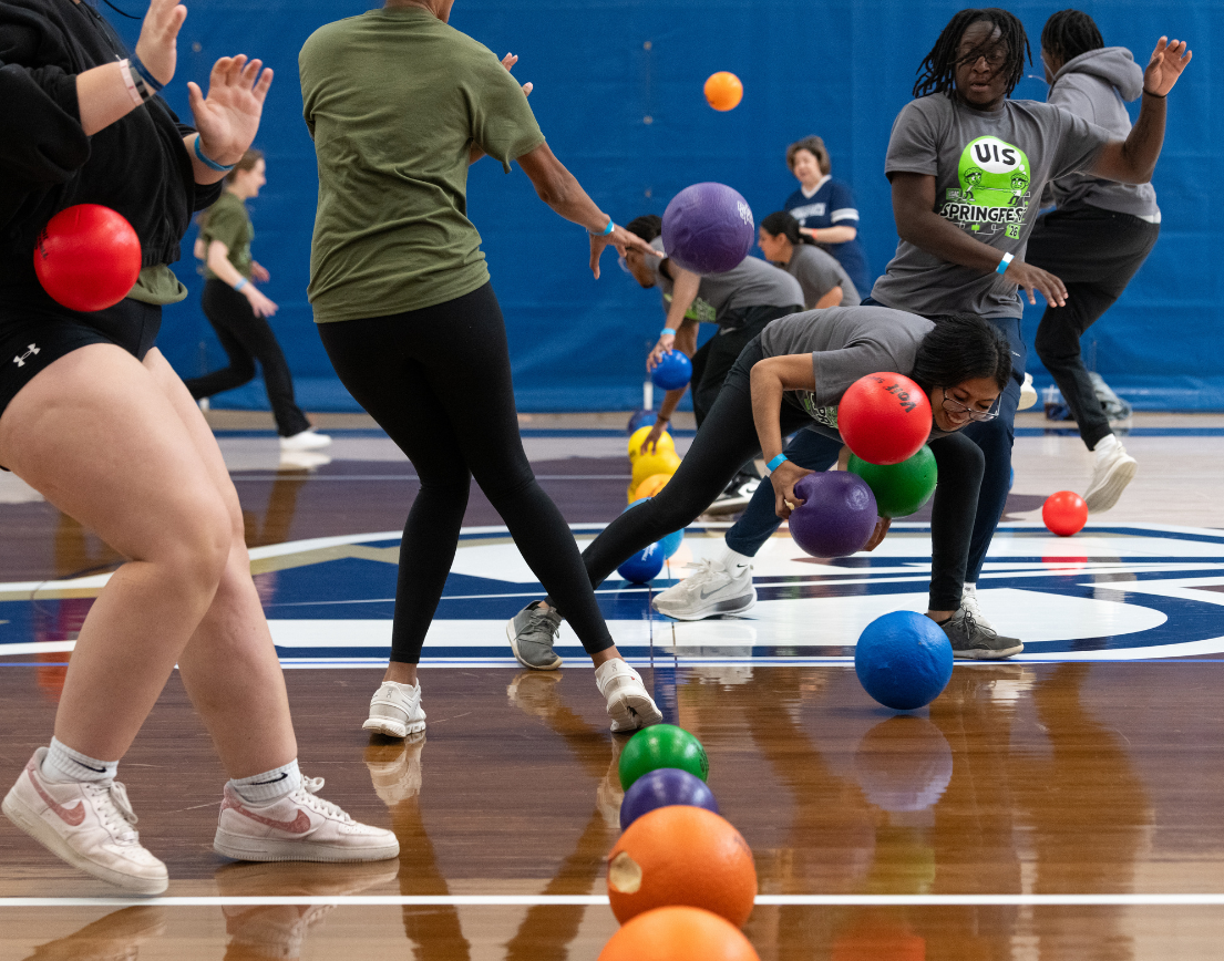 Colorful dodgeballs are being thrown.