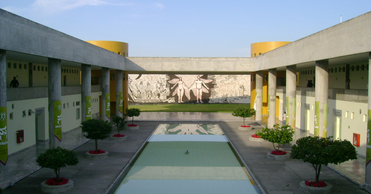 University of Colima reflecting pond with mural of a name and a woman