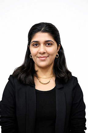 Smiling woman in black blazer against a white background.