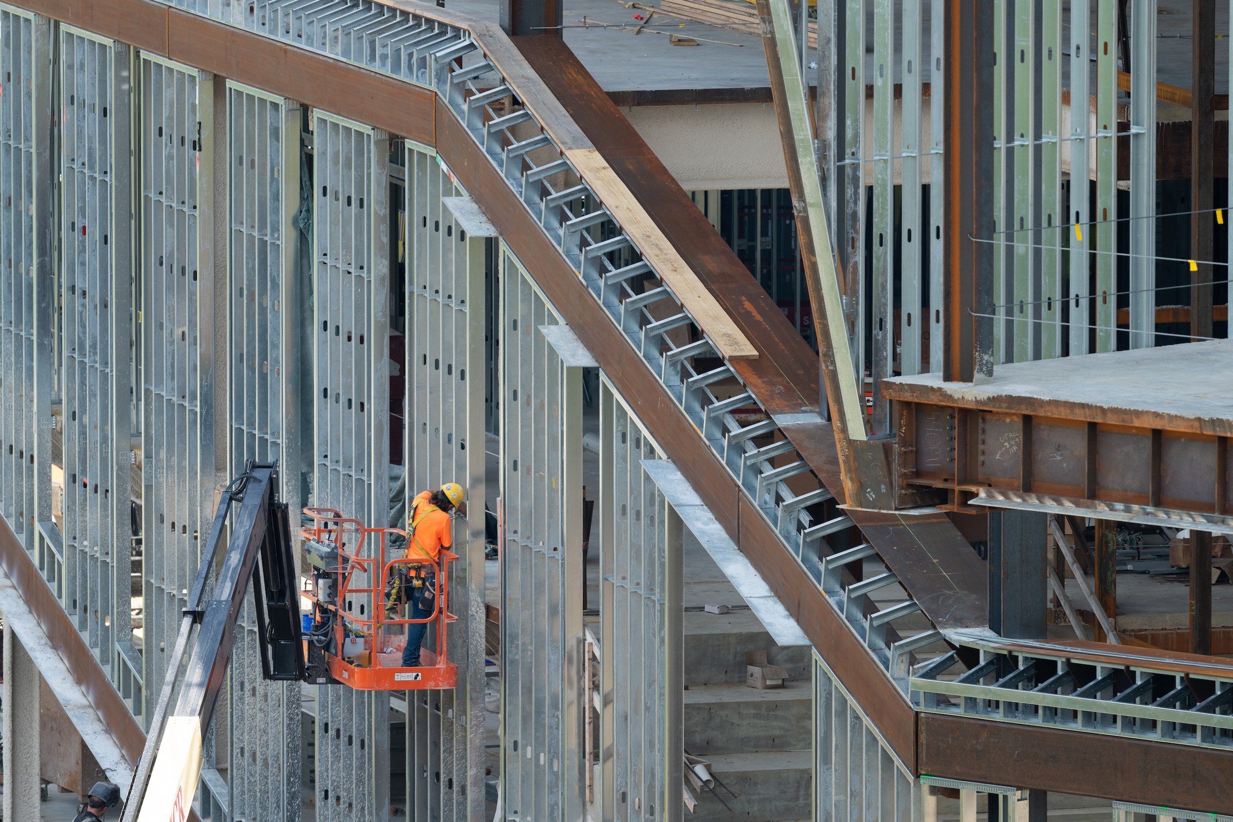 Construction crew member installing exterior framing