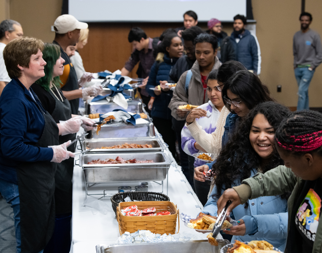 A line of students at a buffet table.