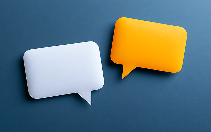 Two speech bubbles, one white and one orange, against a dark blue background.