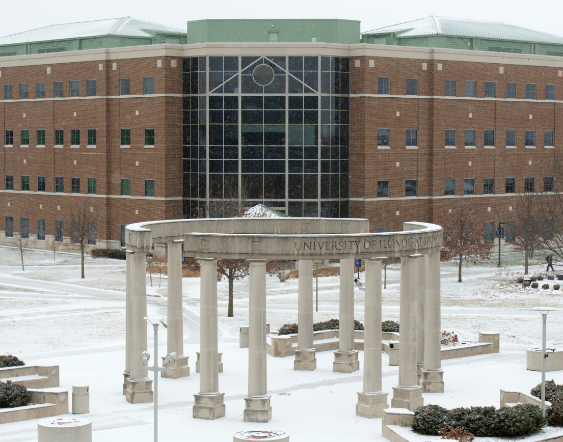 The colonnade and the university hall building surround by snow