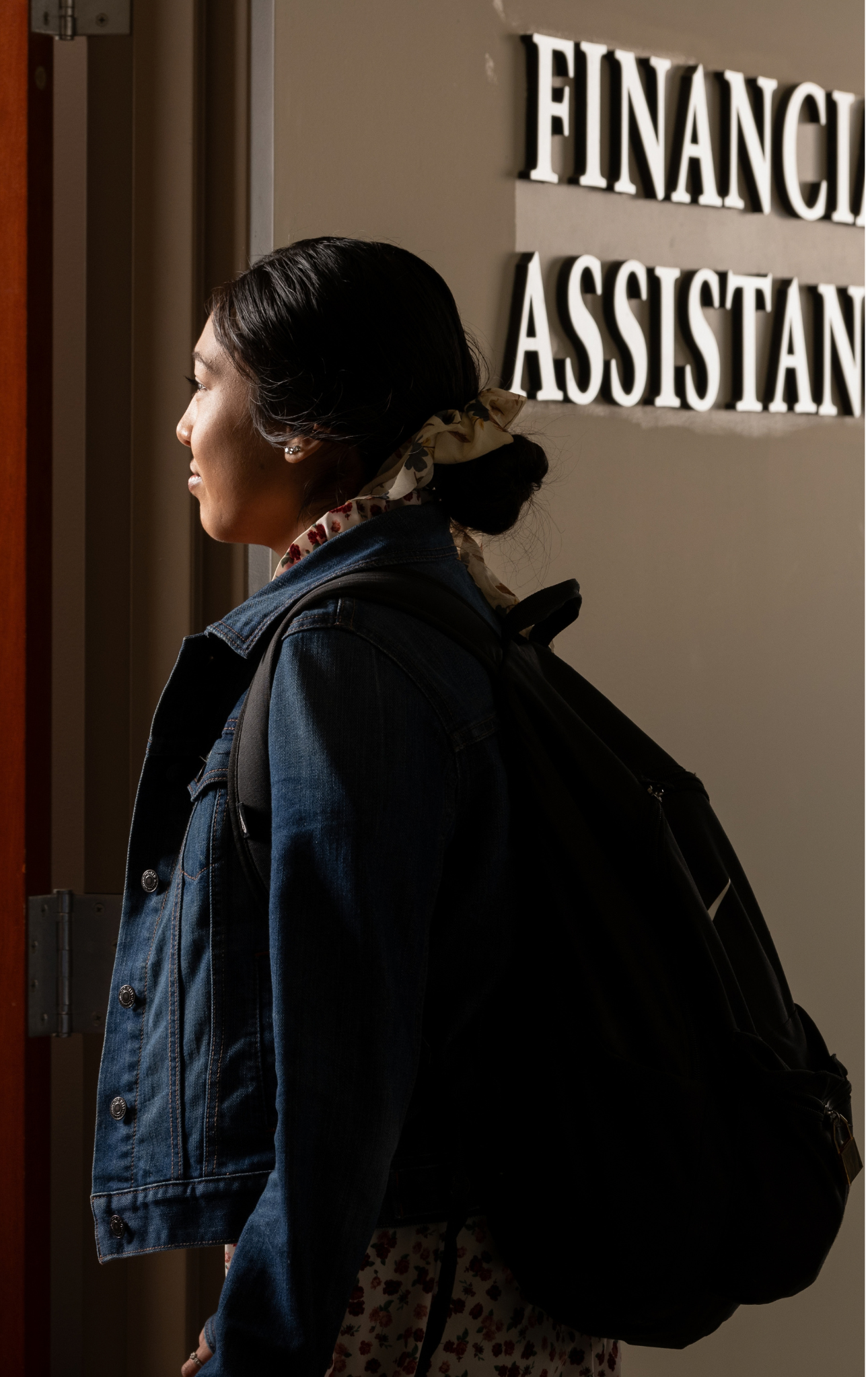 a student walking into the financial aid office