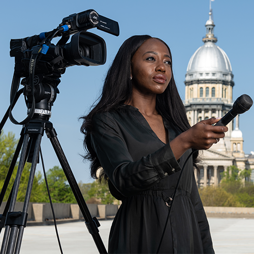 a female PAR student interviewing someone in front of a camera at the state capitol