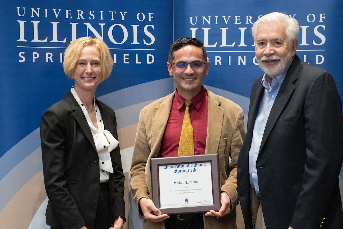 Chancellor Gooch, Serkan Karadas holding an award and Burks Oakley II.