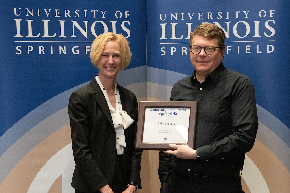 Chancellor Gooch and John Transue who is holding an award