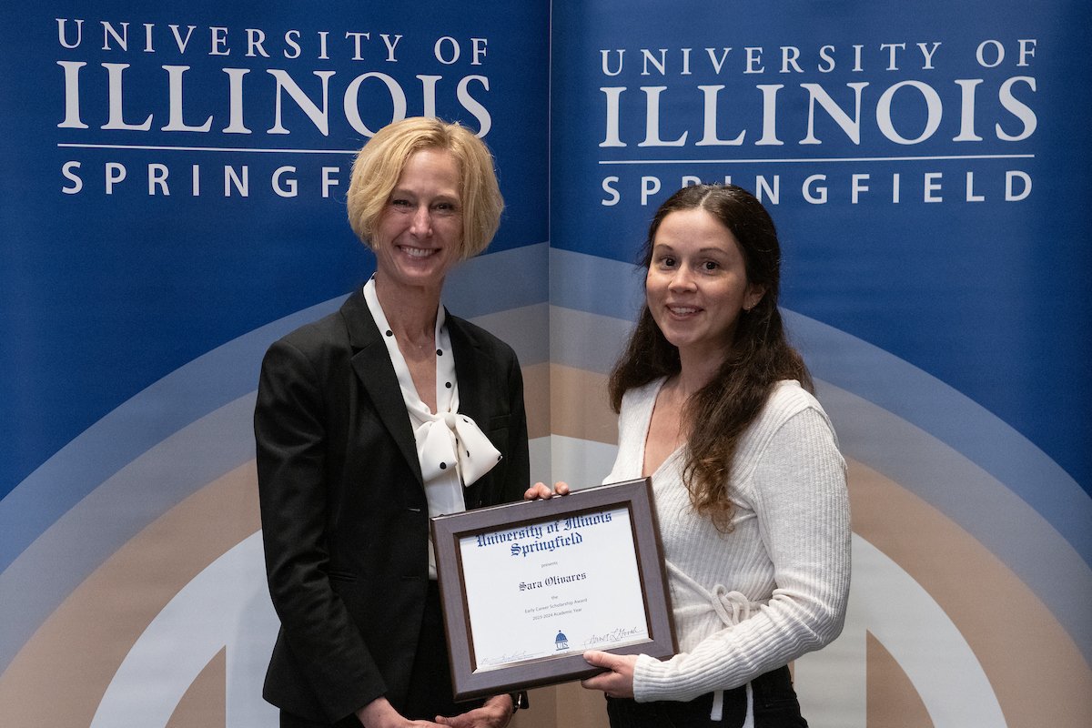 Chancellor Gooch Sara Lupita Olivares who is holding a award.