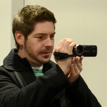 a male UIS student recording with a camera