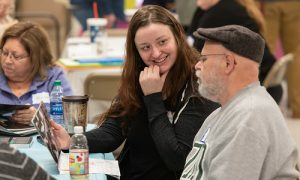 Student helping patient with art therapy