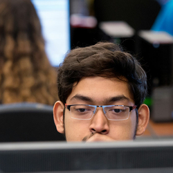 student behind computer screen