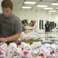a student volunteer making emergency kits for the Red Cross