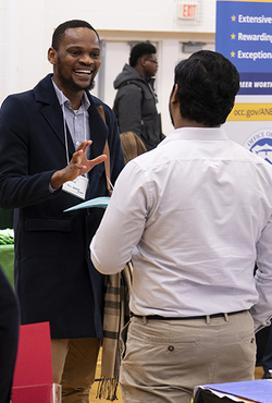 Student talking with employer at expo