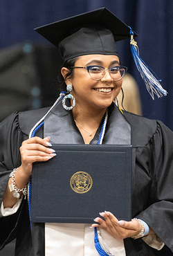 Graduate holding diploma cover