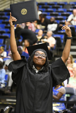 Grad holding diploma 