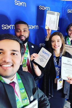 SAM students holding awards
