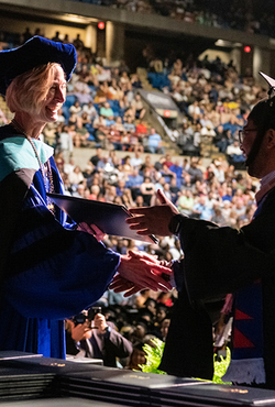 Chancellor Gooch shaking grads hand