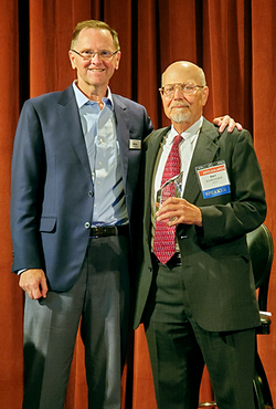 Raymond Schroeder with award