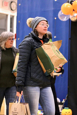 Student holding bags of food