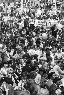 A black and white photo showing a large group of women attending a Equal Rights Amendment (ERA) event.
