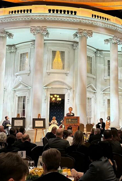 Chancellor Gooch speaks in front of a replica of the White House.