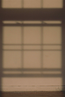 Artwork by Ruby Que that shows the shadow of a window on a wall