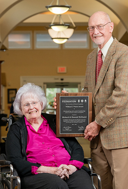 Hannah and Richard McDaniel posing for a photo with the award.