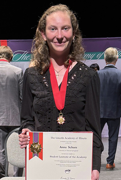 Anna Schurz holding the award