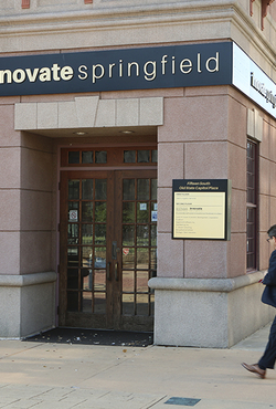 Two people walk past the entrance of Innovate Springfield, a UIS innovation hub in downtown Springfield, Illinois.