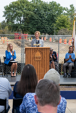 Chancellor Janet Gooch speaks at a podium during the UIS Library Commons groundbreaking ceremony.