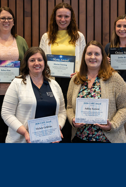 Five women smiling and holding certificates.