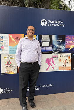 Man standing in front of a poster display at Tecnológico de Monterrey.